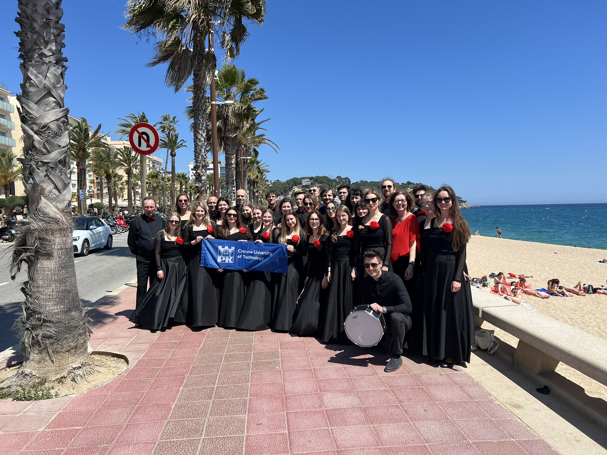 Zdjęcie grupowe Chóru "Cantata" w Hiszpanii, plener, deptak wzdłuż wybrzeża.